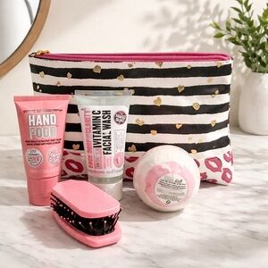 Make up bag with hand lotion, face wash, brush, and bath bomb. New with tags